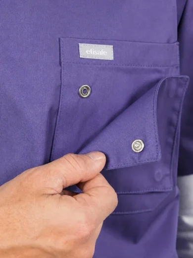 Close-up of a purple work shirt pocket being closed with a snap button; a small white 'efisafe' tag is visible above the pocket.