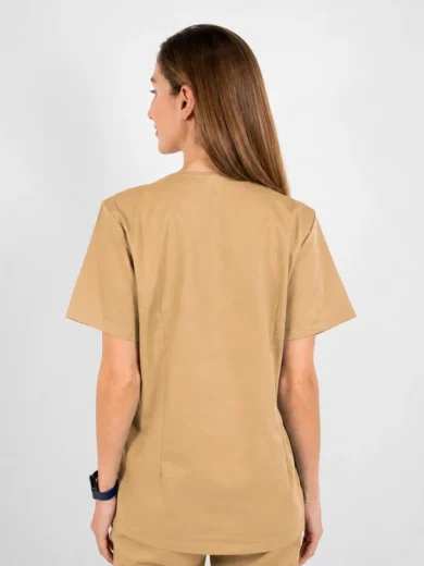 Back view of a person wearing tan short-sleeve medical scrubs, standing against a light background.