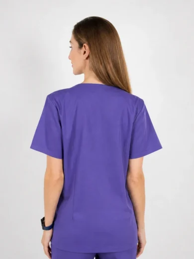Back view of a person in purple medical scrubs, short sleeves, standing against a light gray background.