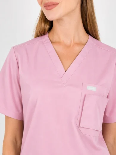 Pink short-sleeve scrub top with a V-neck and a front chest pocket.”
