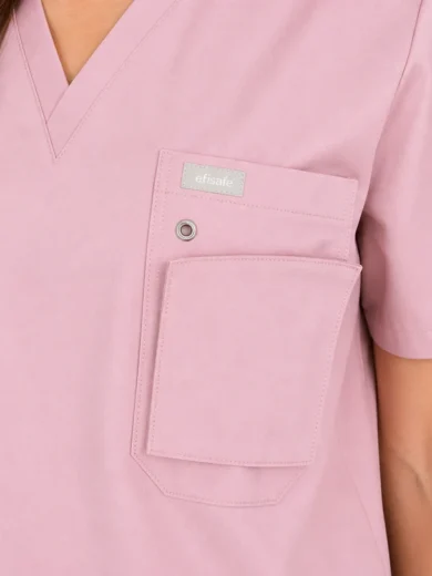 Light pink scrubs top with a large chest pocket and a smaller pocket, featuring a small brand tag that reads 'efisafe' near the top pocket.