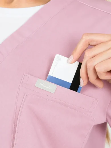Person in pink scrubs places a card into the chest pocket, pocket badge visible on the uniform.