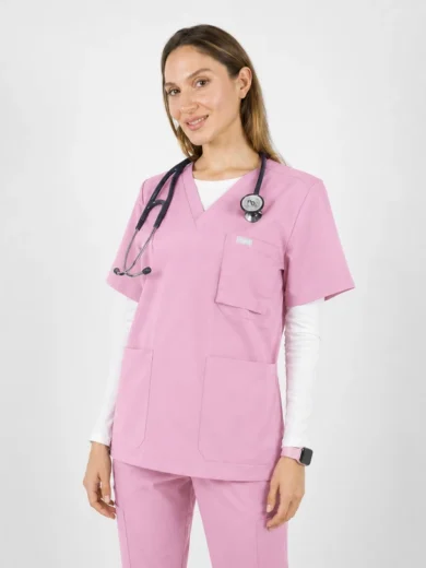 Female healthcare professional in pink scrubs with a stethoscope, smiling at the camera.
