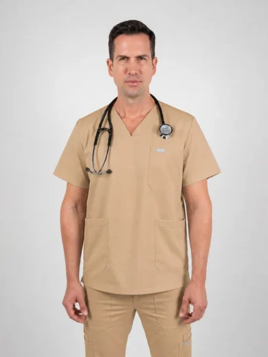 Male healthcare professional in beige scrubs with a stethoscope around his neck, standing against a light gray background.