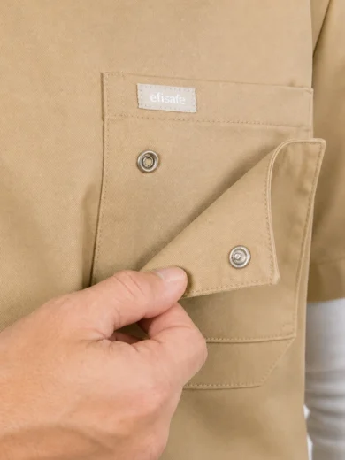 Close-up of a hand opening a beige work shirt pocket with metal snap buttons and a small 'efisafe' label on the pocket.