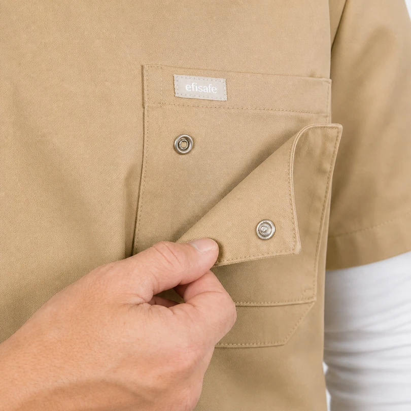 Close-up of a hand opening a beige work shirt pocket with metal snap buttons and a small 'efisafe' label on the pocket.