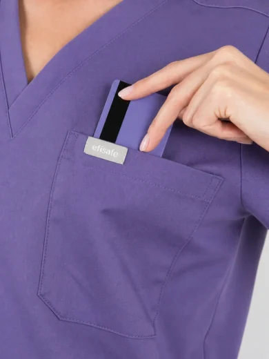 Nurse in purple scrubs inserts a purple badge card into a front chest pocket labeled efisafe.