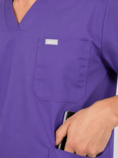 Purple medical scrubs with a chest pocket and a phone tucked into the lower pocket.