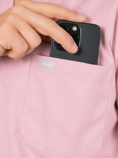 Person in a pink shirt places a black smartphone into a chest pocket labeled efisafe.