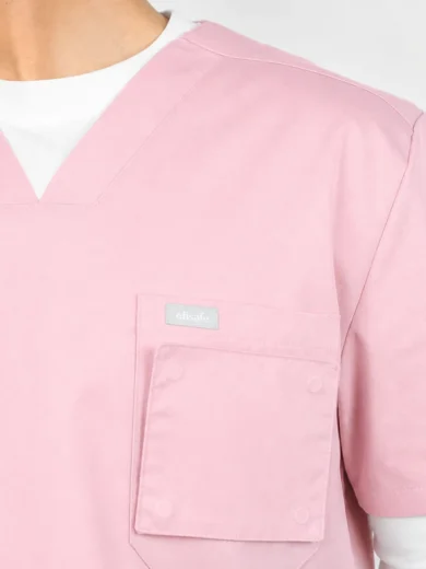 Pink medical scrubs top with chest pocket and small logo tag reading 'efisafe' on the pocket area