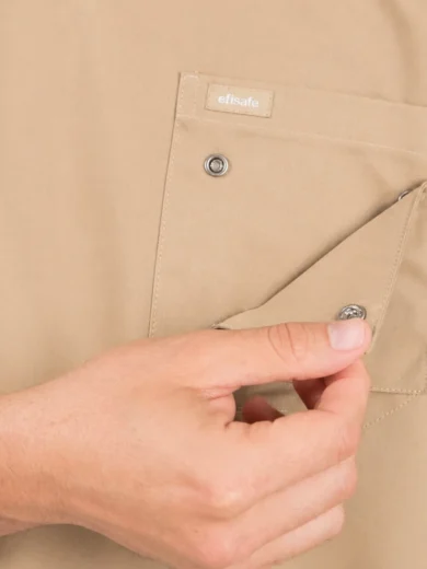 Beige work shirt pocket being opened to reveal a metal snap button, with an 'efisafe' label on the pocket.