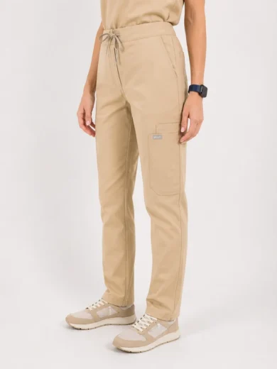 Beige drawstring-waist cargo pants with a large side pocket, worn with beige sneakers by a model.