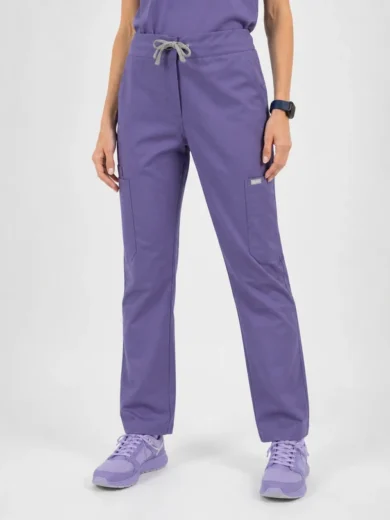 Person wearing lavender scrub pants with a drawstring waist and cargo pockets, paired with lavender sneakers.