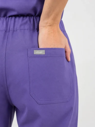 Back view of purple pants with a hand in the pocket, showing a square back pocket and a smallEfisafe label.