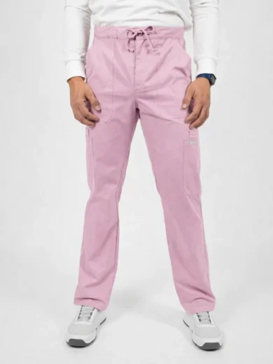 Person standing in light pink cargo scrub pants with a drawstring waist, paired with a white long-sleeve shirt and white sneakers.
