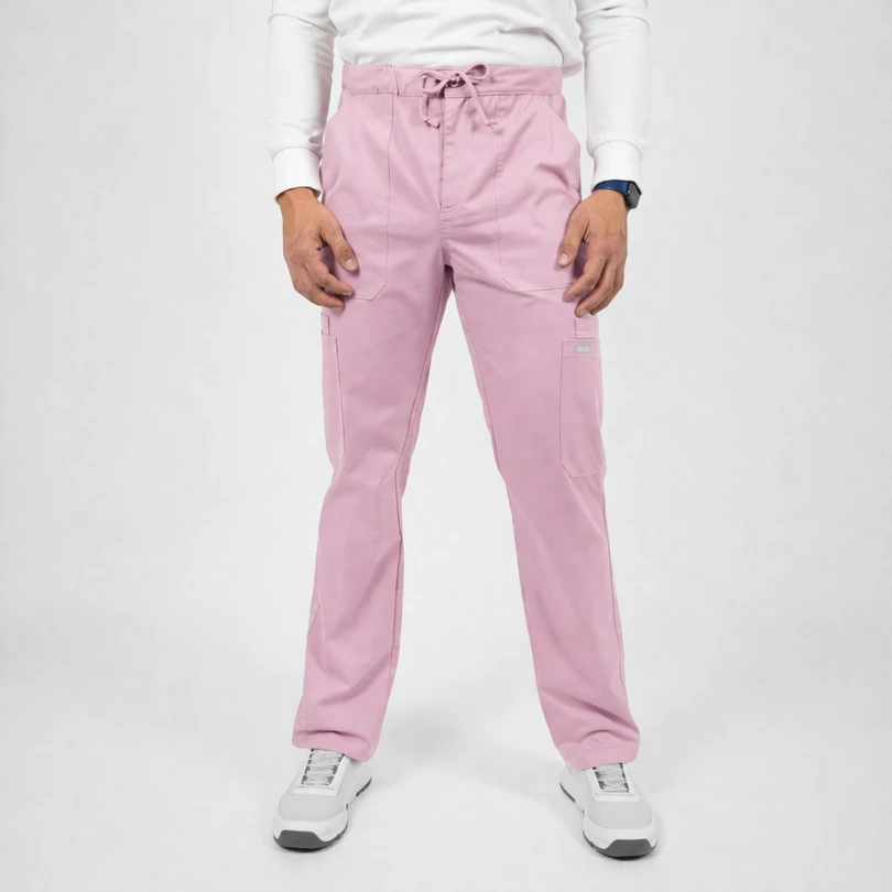 Person standing in light pink cargo scrub pants with a drawstring waist, paired with a white long-sleeve shirt and white sneakers.