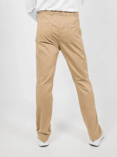 Back view of a person wearing tan cargo pants with elastic waistband and large back pockets, white sneakers.