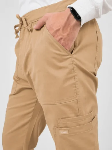 Tan cargo pants with a drawstring waist; hand in pocket and a smartwatch on the wrist (close-up product shot).