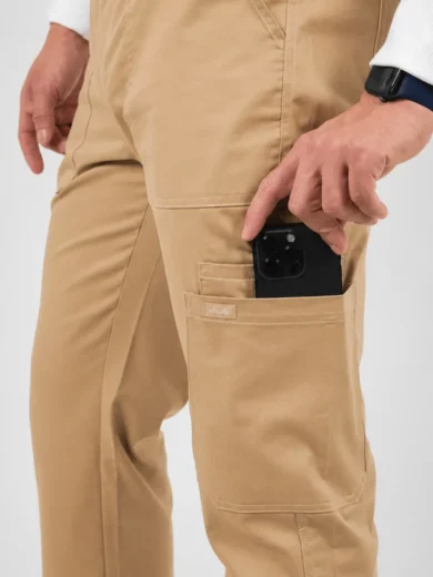Person in tan cargo pants places a black smartphone into a side pocket on the leg pocket area.