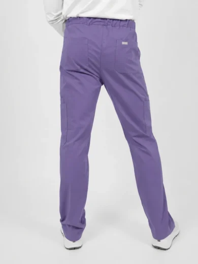 Back view of purple scrubs pants with an elastic waistband and rear pockets, worn with a white top and white shoes.