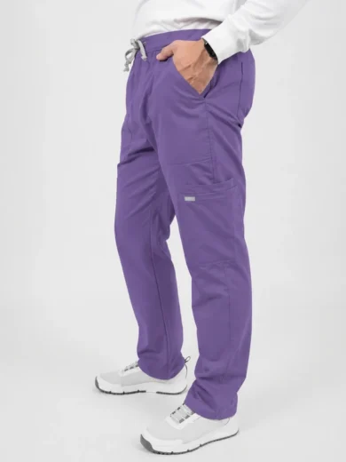 Person wearing purple jogger pants with a drawstring waist and side pocket, paired with white sneakers and a white top, standing casually with hands in pockets